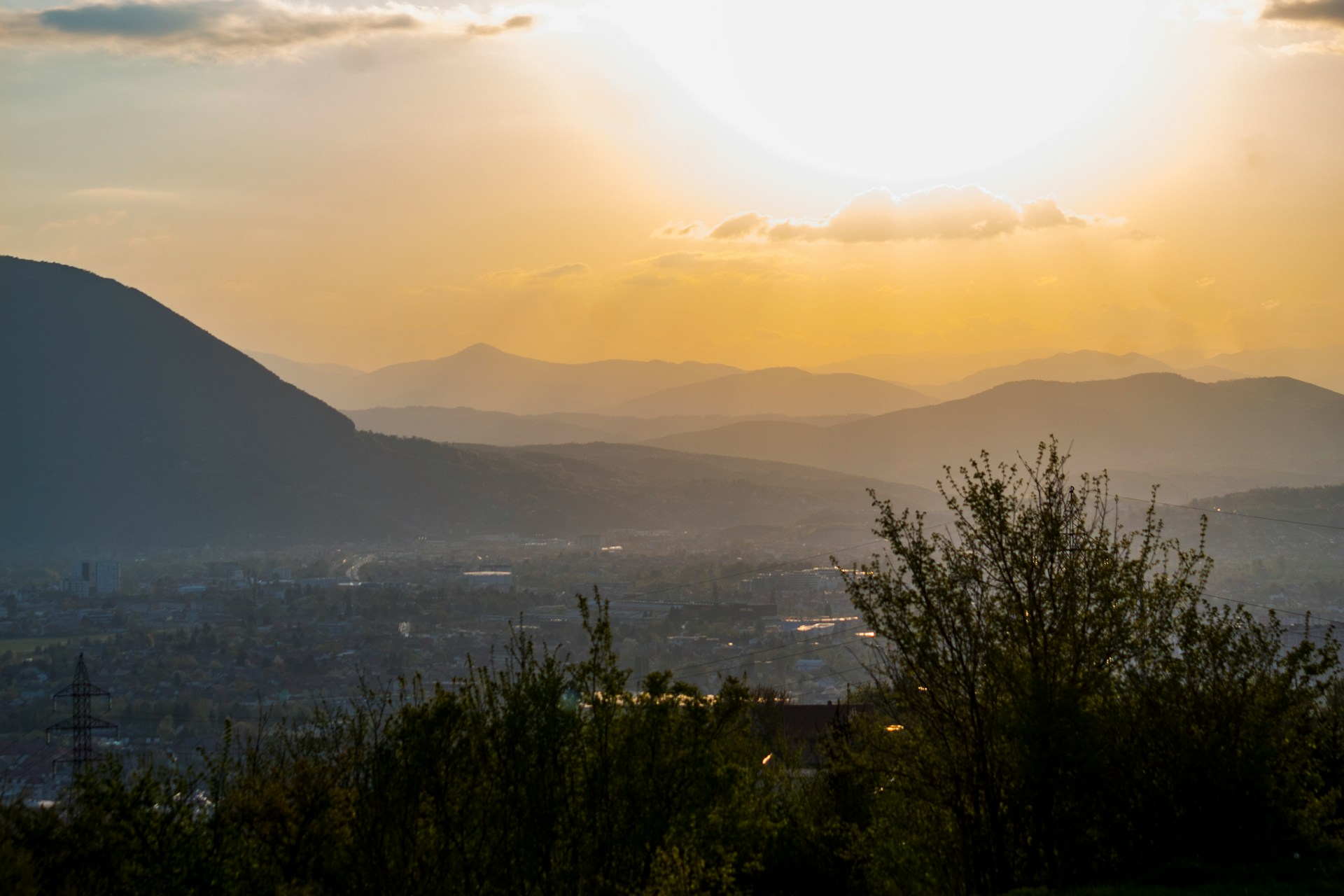 Mountain ridges and valley layers under low golden sidelight